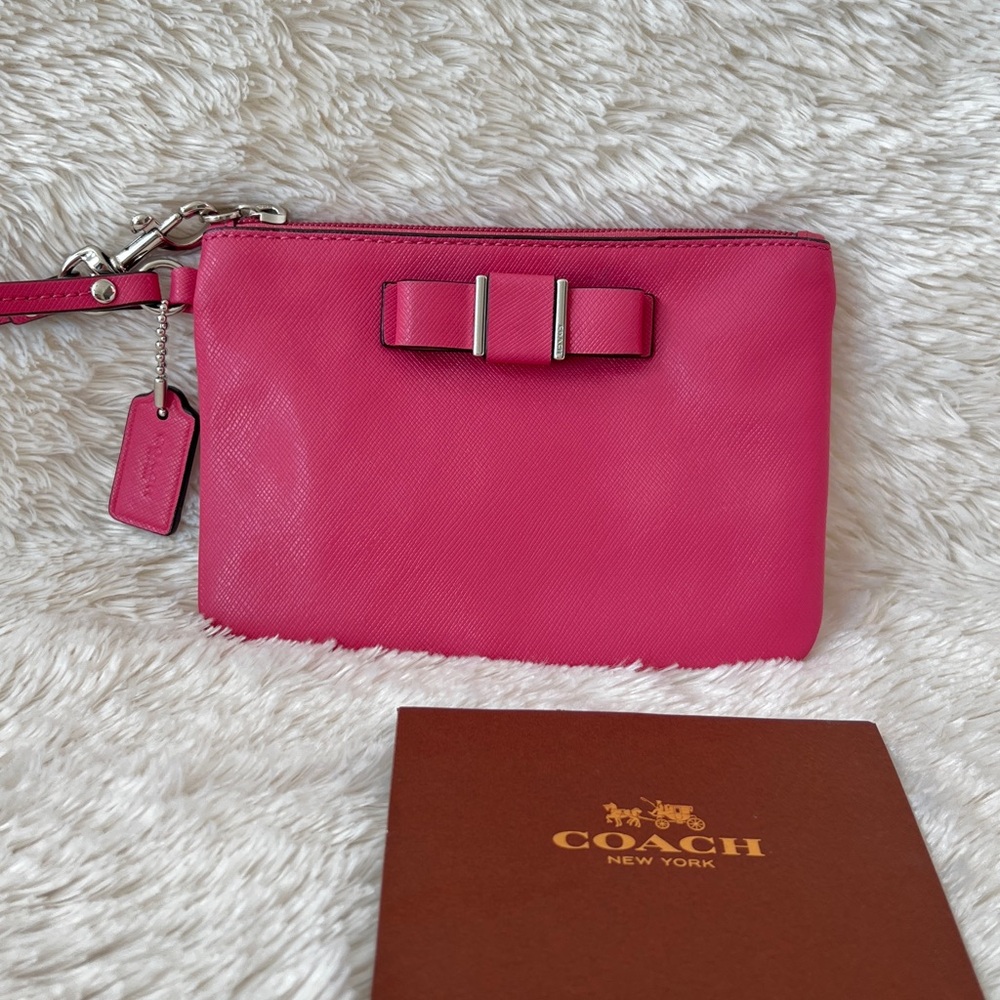 Authentic Coach Darcy Bow small wristlet in pink saffiano leather.